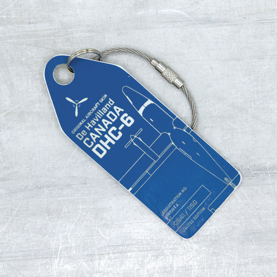 Close-up of engraved blue Aviationtag from de Havilland DHC-6 Twin Otter, featuring serial number and aircraft registration