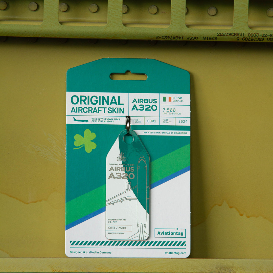 Green and white Aviationtag upcycled from former Aer Lingus Airbus A320EI-CVC - authentic aircraft tag with its cardboard packaging on an aircraft panel