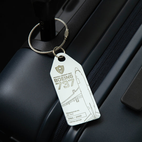 Aviationtag Boeing 737-200 Republique du Niger Aircraft Tag Edition - Moody photo of a white plane tag on a black suitcase