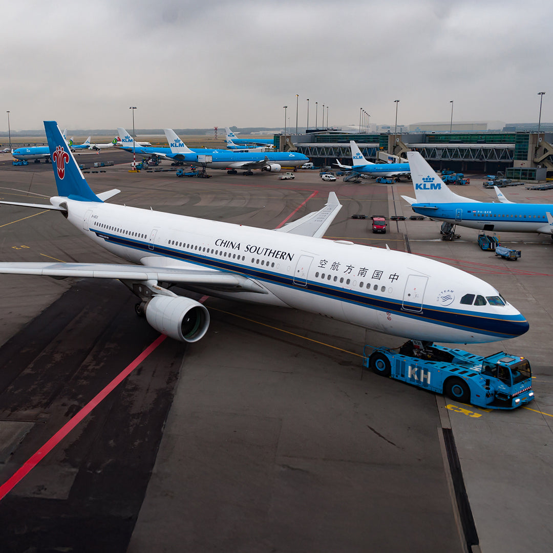 Aviationtag made from China Southern Airbus A330-200 B-6531 fuselage – upcycled aircraft skin, limited edition plane tag, aviation memorabilia. Image showing the aircraft at AMS airport