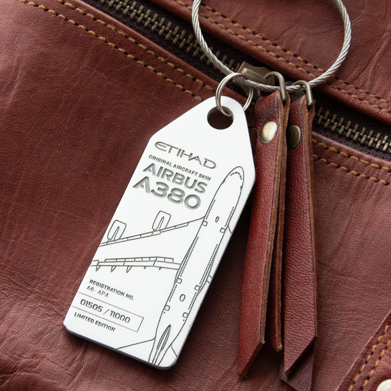 Aviationtag x Etihad Airbus A380 Plane Tag Edition A6-APA White Aircraft Tag on a brown leather bag as luggage tag