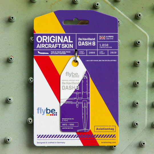 Aviationtag Flybe Tribute Edition Dash 8 G-PRPG aircraft tag purple white with packaging on aircraft panel