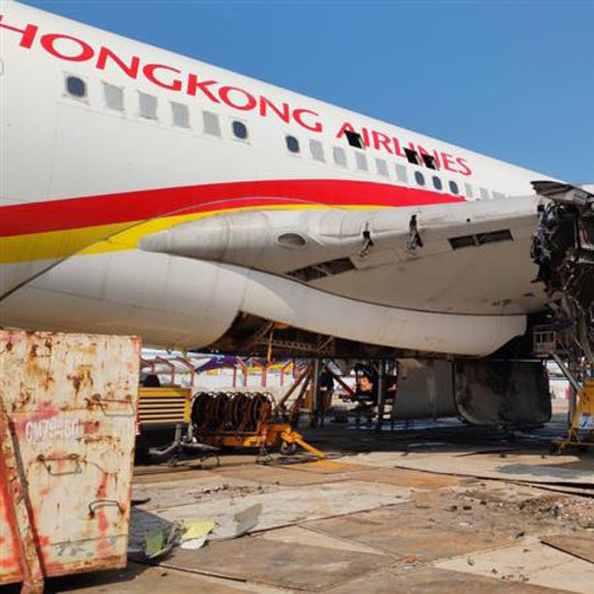 Airbus A330 B-LNF during teardown at Hong Kong International; upcycled aircraft material cut from fuselage and made into Aviationtag plane tags.