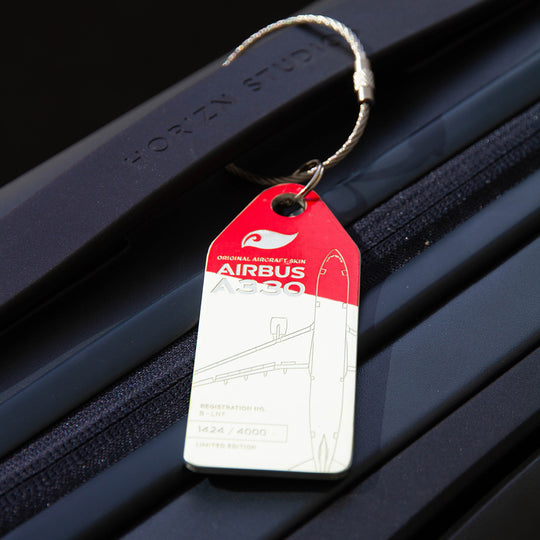 Lifestyle shot: Aviationtag keychain on luggage—plane tag from Hong Kong AIrlines Airbus A330 B-LNF