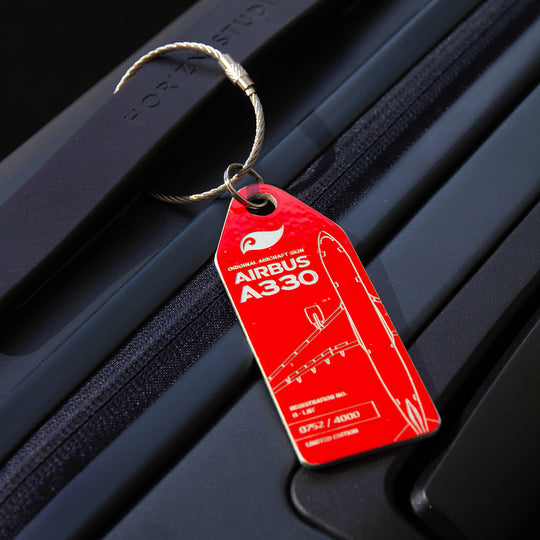 Lifestyle shot: Aviationtag keychain on luggage—plane tag from upcycled aircraft material (Airbus A330-223 B-LNF), aviation memorabilia for collectors.
