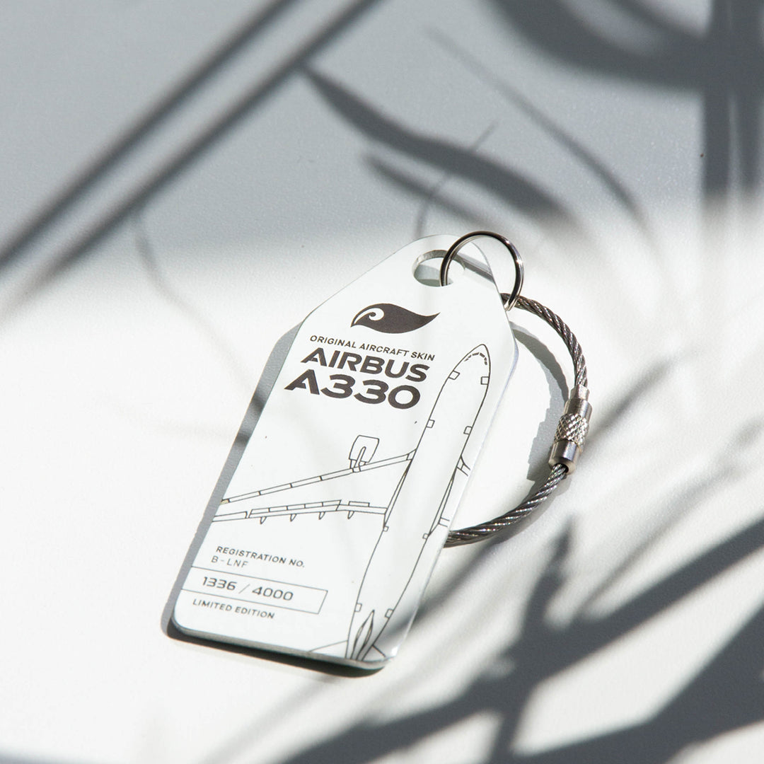 Mood shot: Aviationtag keychain plane tag from upcycled aircraft material (Airbus A330-223 B-LNF), aviation memorabilia for collectors.