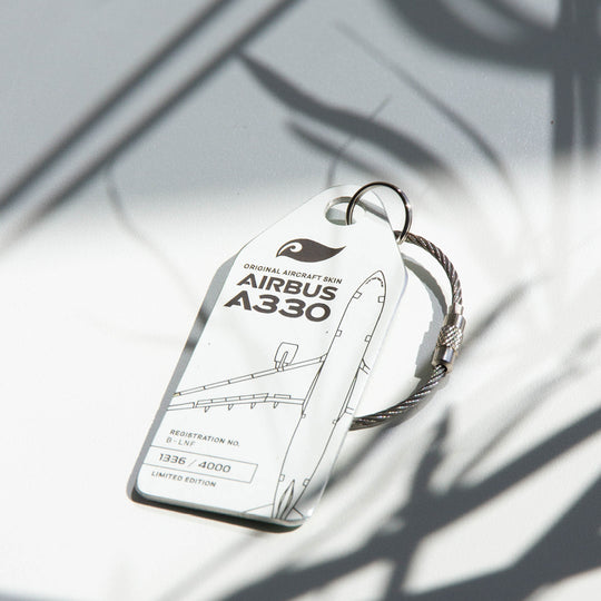 Mood shot: Aviationtag keychain plane tag from upcycled aircraft material (Airbus A330-223 B-LNF), aviation memorabilia for collectors.