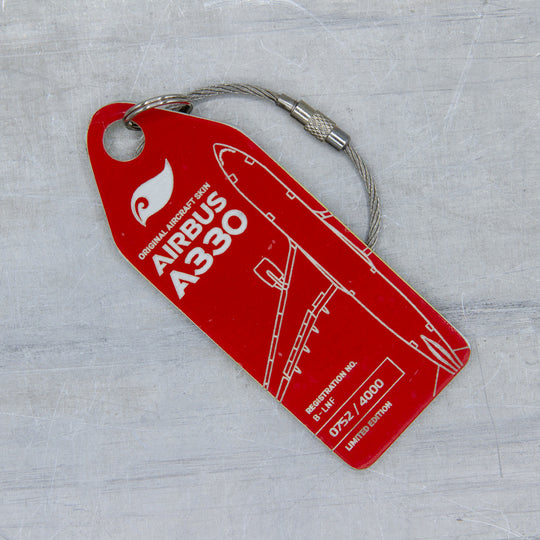 Close-up of aircraft tag cut from upcycled fuselage panel—red Aviationtag from Airbus A330 B-LNF; authentic patina and precise engraving 