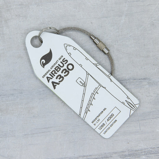 Close-up of white aircraft tag cut from upcycled fuselage panel—Aviationtag from Airbus A330 B-LNF; authentic patina and precise engraving 