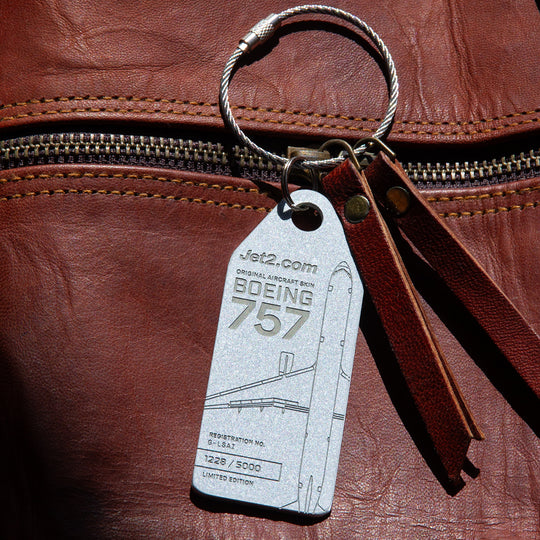 Aviationtag's Jet2 silver aircraft tag clipped to carry-on luggage 