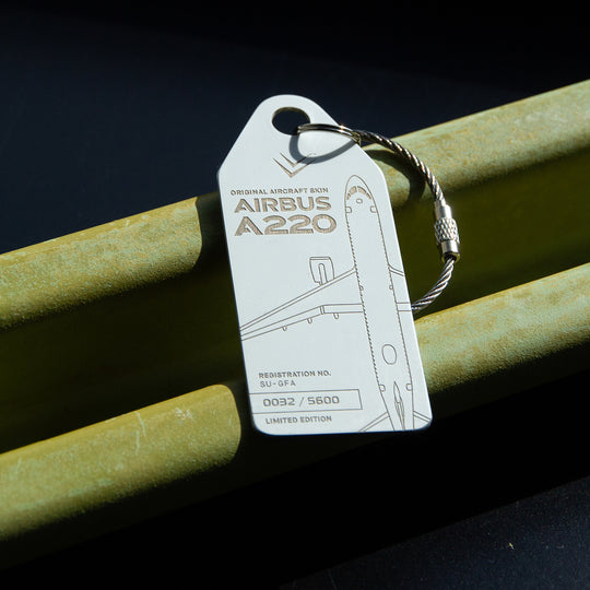 Aviationtag Airbus A220 SU-GFA Edition ex-Egypt Air - White aircraft tag on aircraft material in a moody shot