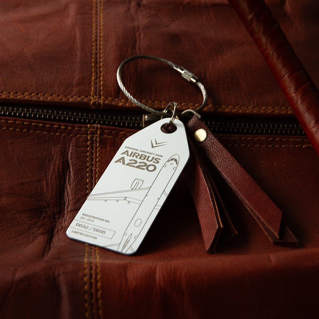 Aviationtag Airbus A220 SU-GFA Edition ex-Egypt Air - White aircraft tag as a bag tag on brown leather bag